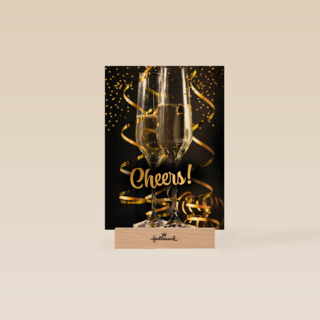 cheers with a glass champagne and confetti